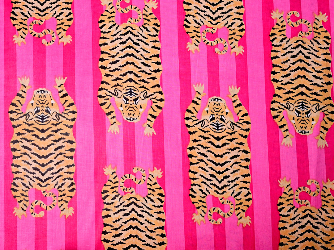 Multicolor tiger print cotton fabric with bold and vibrant patterns.