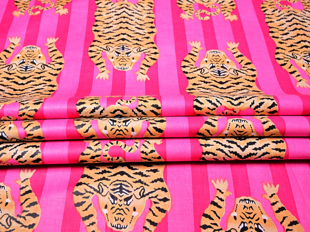 Exotic jungle-inspired tiger print cotton fabric in multicolor hues.