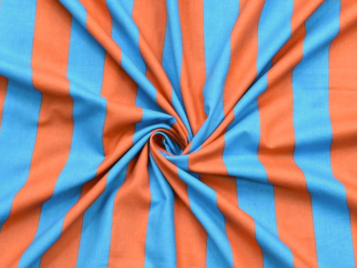Turquoise and orange striped fabric laid next to a ruler showing the 44 inch width.