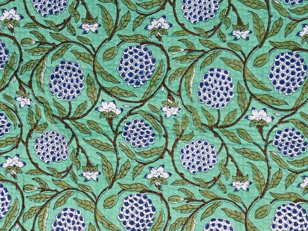 Mint green quilted cotton fabric with blue floral and botanical vine pattern