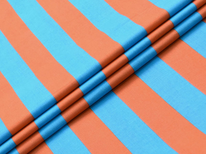 Flat lay photo of turquoise and orange vertical stripe fabric showing the repeat pattern.