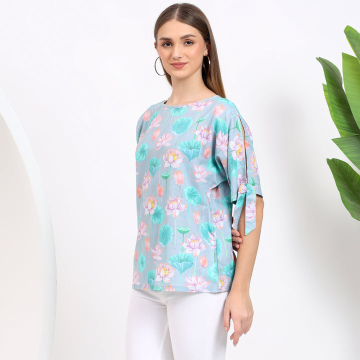 Casual and office-ready light blue floral top, offering comfort and style with its feminine design.