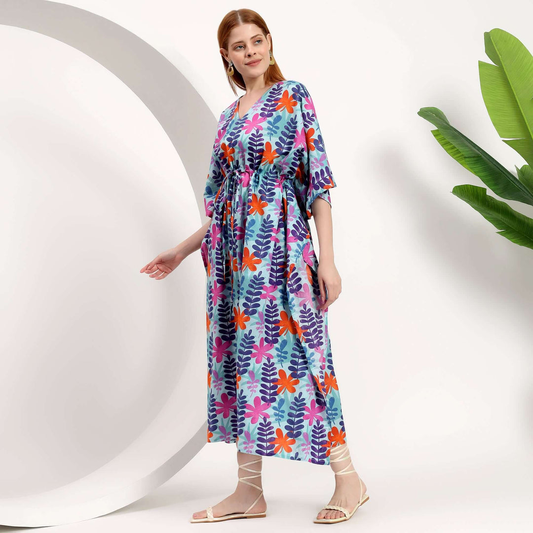Model wearing a wholesale Moroccan kaftan dress with vibrant floral patterns, showcasing style and comfort.
