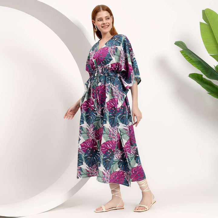 Women modeling a stylish wholesale beach kaftan dress with vibrant floral prints, perfect for summer outings.