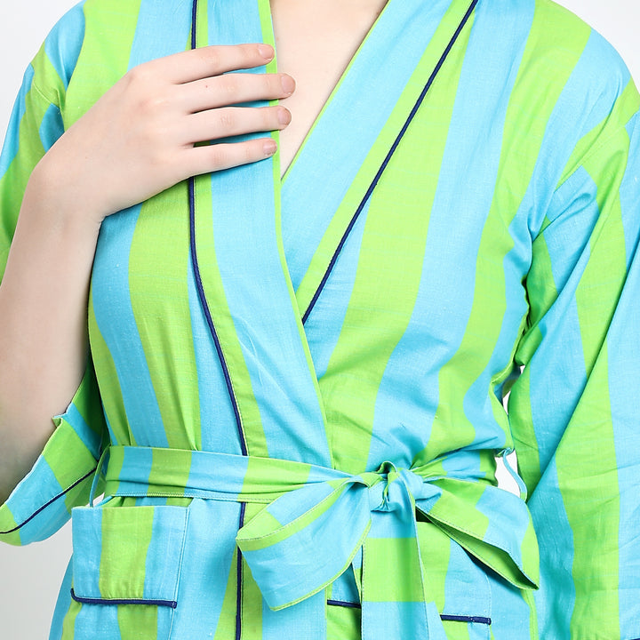 Close-up of v-neck with black piping and waist tie on green nightgown