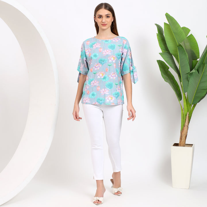 Floral print light blue top, ideal for pairing with jeans or skirts for a fresh, trendy look.