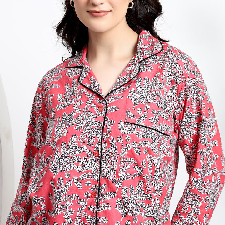 Close-up of women’s pink cotton pajama set showing front pocket detail and elegant contrast piping