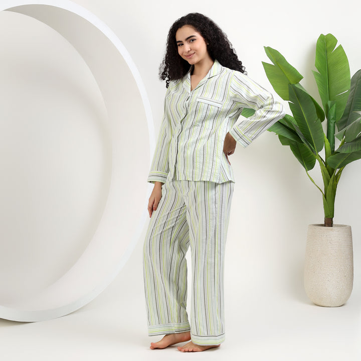 womens family matching cotton striped pajamas in light green stripes model standing with plants