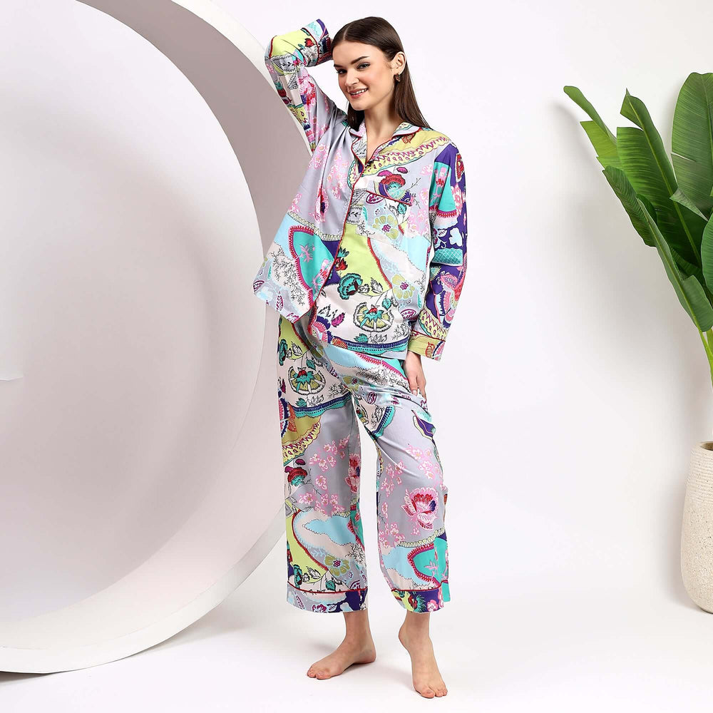 Floral cotton pajama sets for women showcased by a model posing in a bright and colorful sleepwear ensemble.