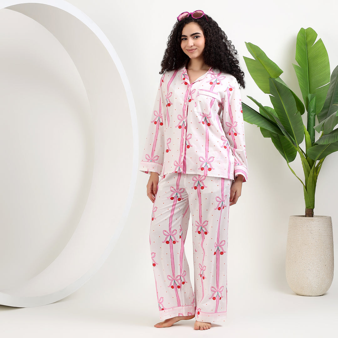 Women's Organic Cotton Holiday Pajama Set featuring pink bow print, perfect for cozy, festive nights.