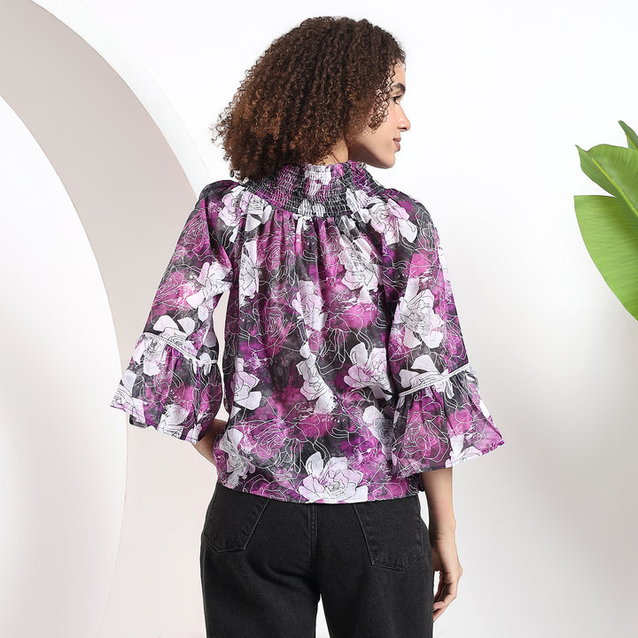 Back view of the purple floral top, showing the sleek design and fit.