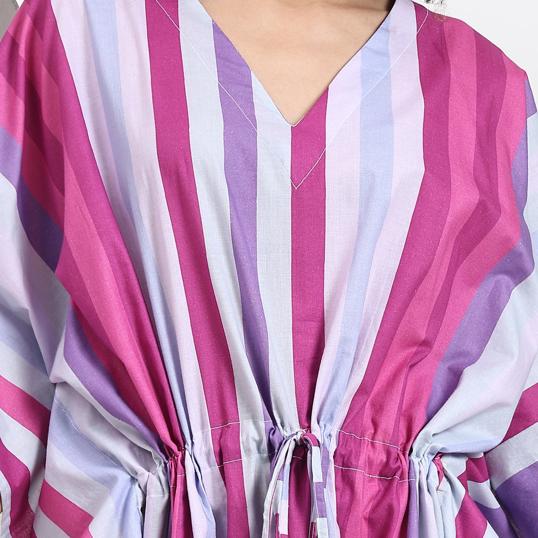 Close-up of a pink striped kaftan maxi dress showcasing its elegant V-neck design