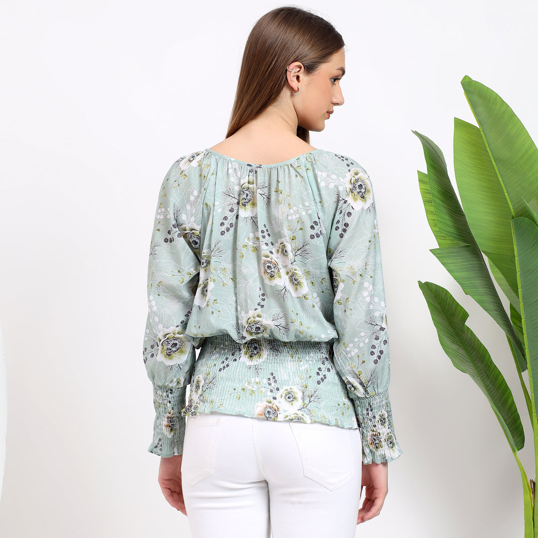 Soft bishop sleeves with a ruffled detail, adding volume to the floral top