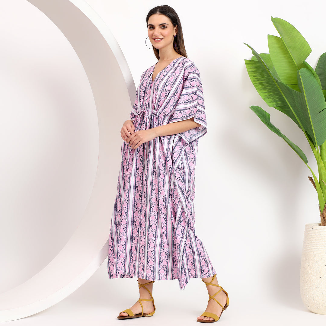 Side angle of a striped kaftan dress for curvy women, showcasing its airy fit and stylish design ideal for summer outings