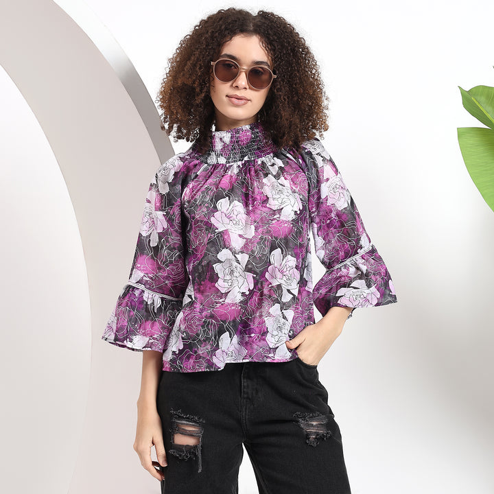 Purple top with bishop sleeves, highlighting the flowy and voluminous style.