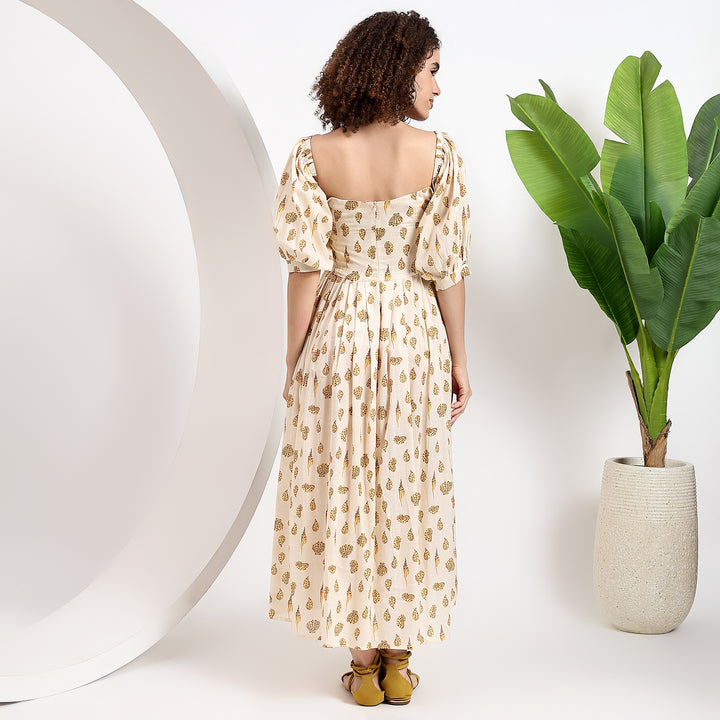 Light and airy yellow maxi dress with an elegant, flowing skirt and timeless puff sleeves.