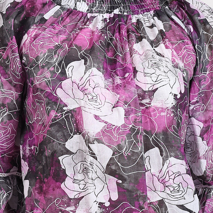 Close-up of floral print on the purple top, showcasing vibrant and feminine design