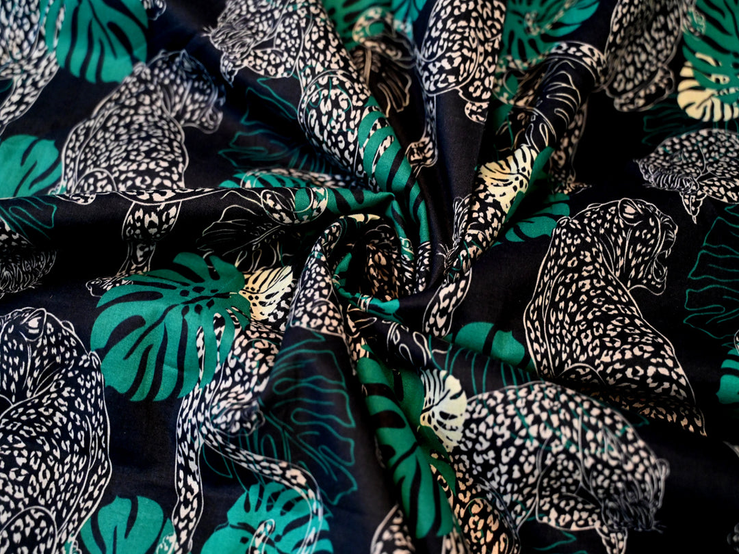 fabric with animal print and green  leaves fabric by the yard