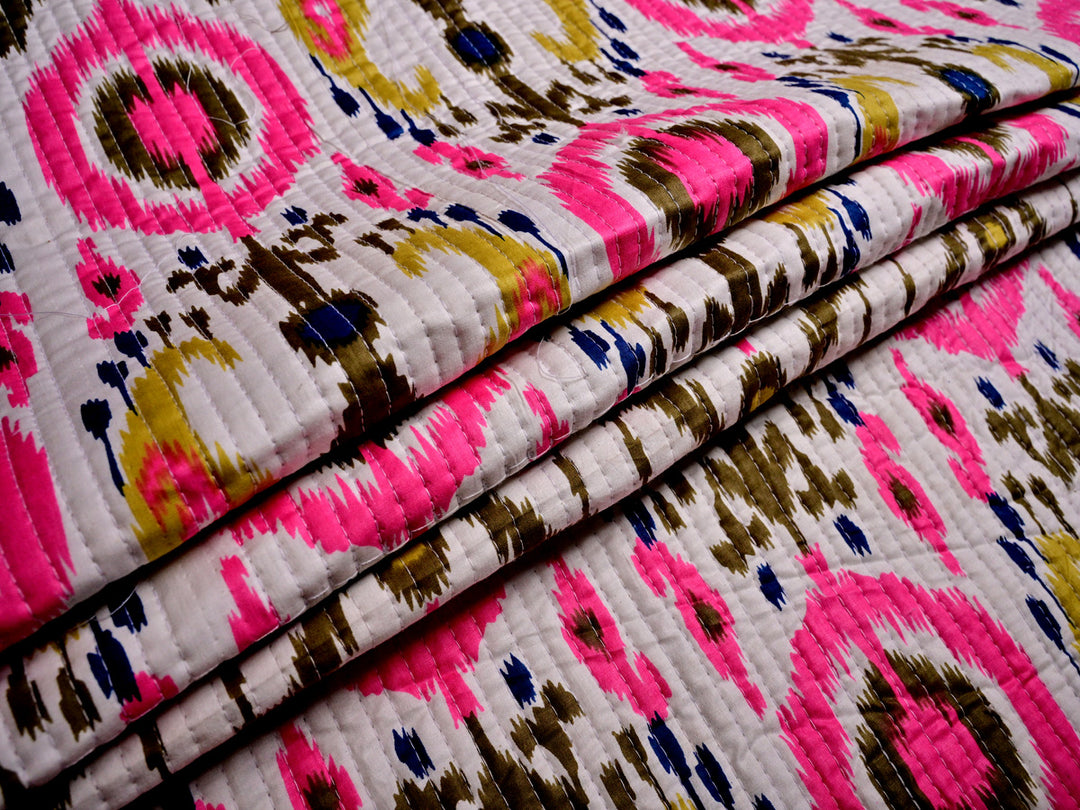 Pre-quilted white ikat print fabric, breathable cotton for bedding, apparel, and DIY sewing projects.