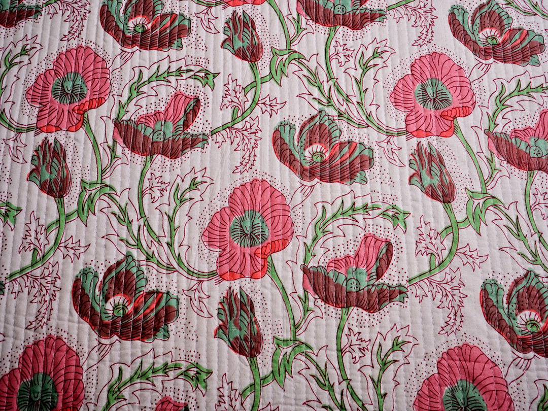 Soft quilted fabric in a pink flower design, 100% cotton, great for creative sewing projects and DIY crafts.