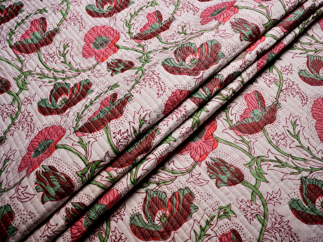 Pink floral cotton fabric, pre-quilted and lightweight, perfect for upholstery, cushion covers, and home sewing projects.