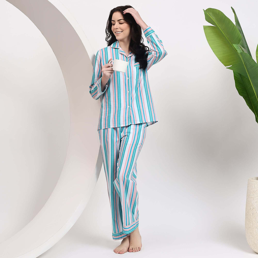 Woman in Stripe Prints Pajama Set Cotton Pajamas for Women, holding a cup and relaxing in stylish cotton pajamas.