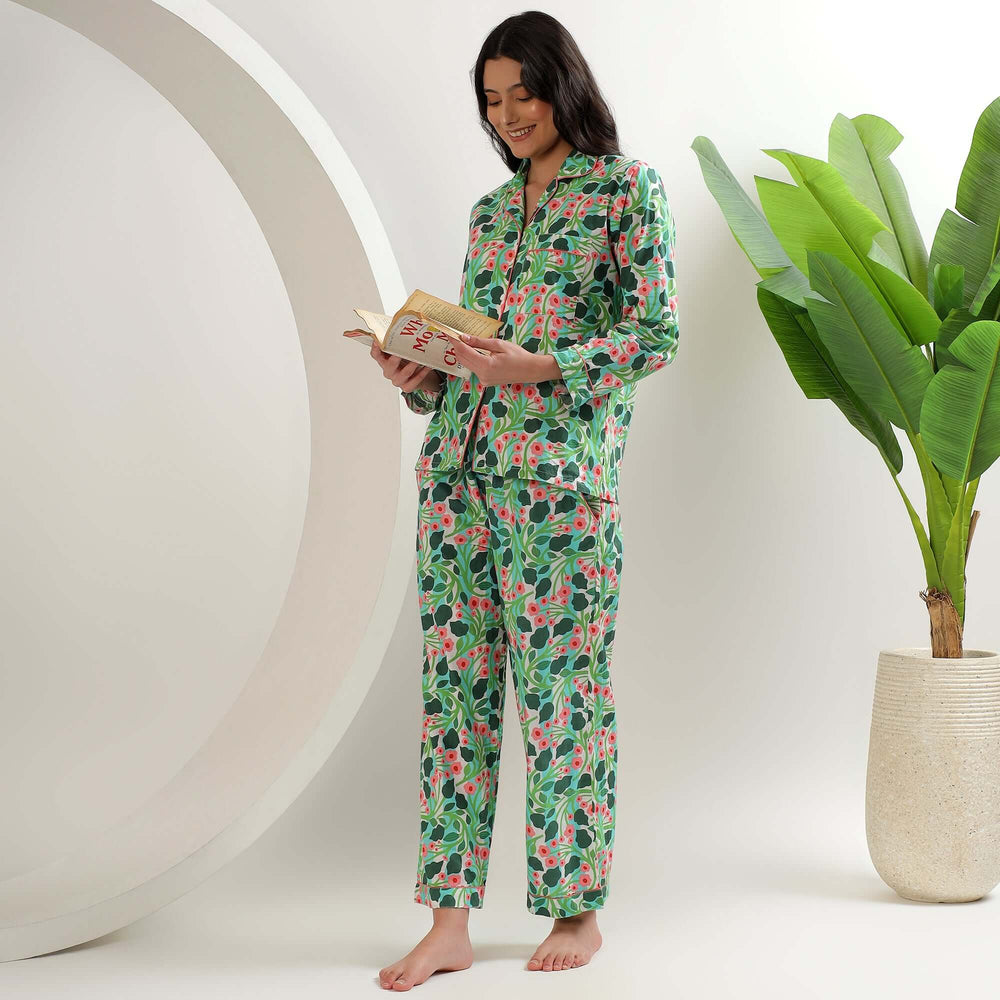 Floral Block Print Pajamas Set & Sleepwear model reading a book in colorful cotton pajamas with floral design.