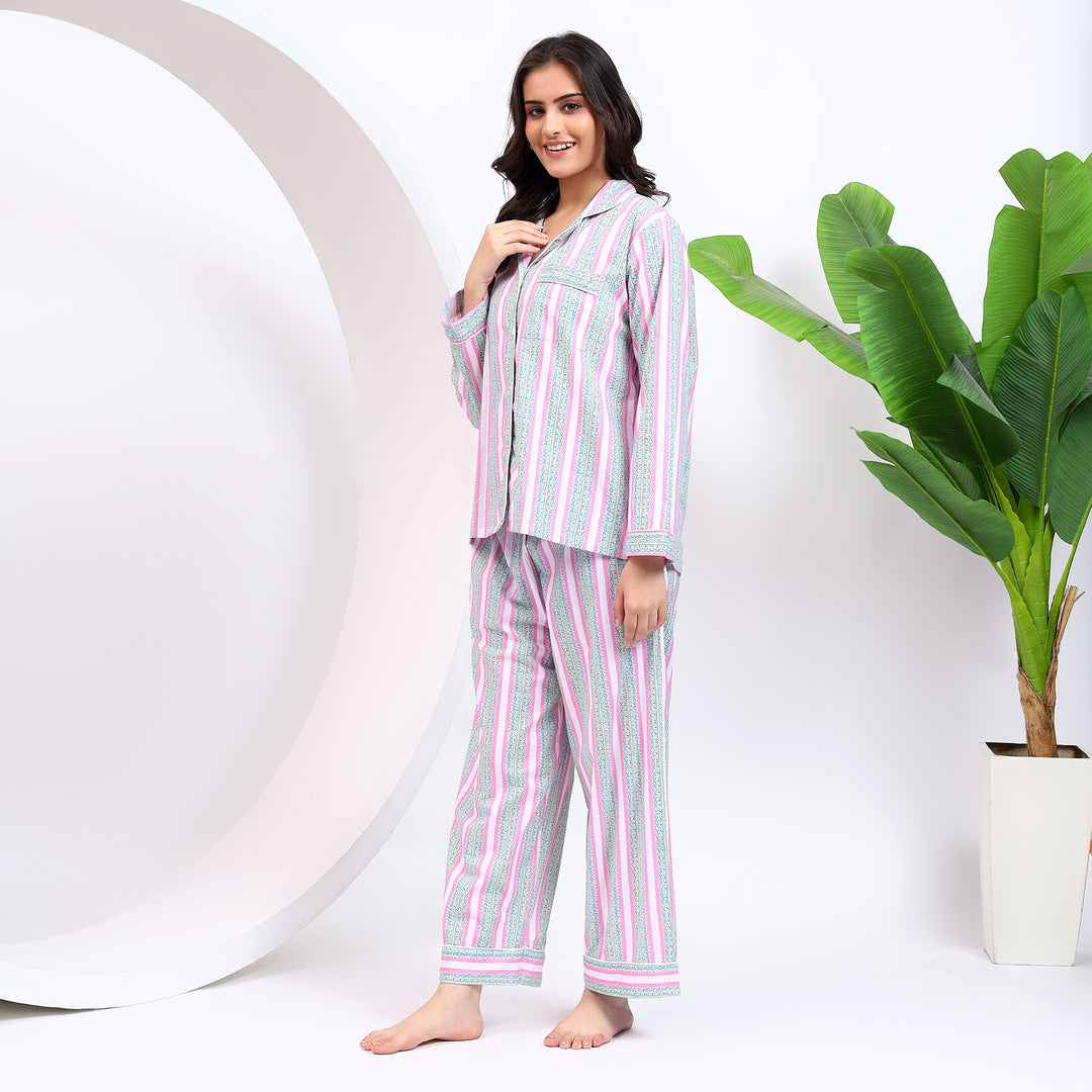 Side angle showing relaxed fit of pink striped nightwear ensemble