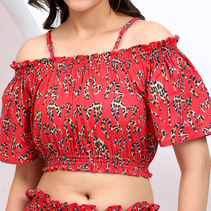 Close-up of red cold shoulder blouse featuring a soft elastic waist and fitted strap for a comfortable fit.