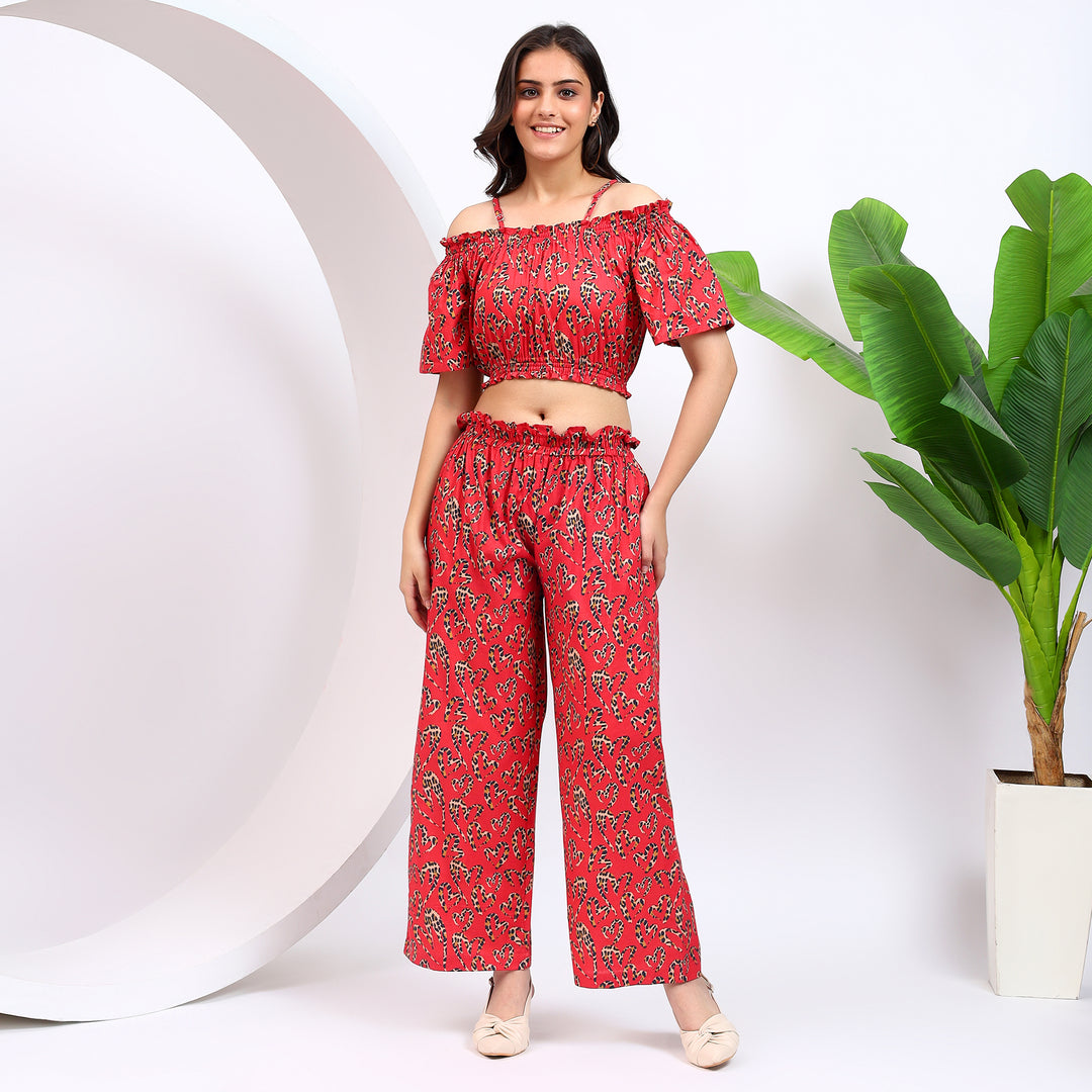 Front view of women's red off-the-shoulder top paired with elegant wide-leg palazzo pants