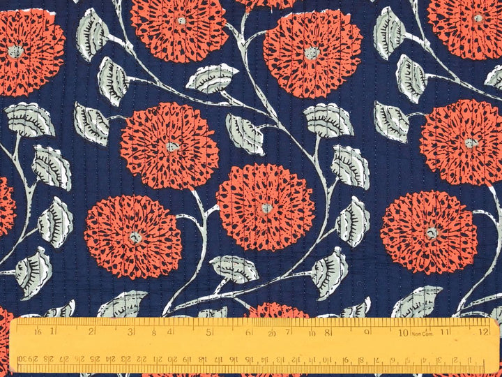 Reversible quilted fabric showing navy and white striped reverse side