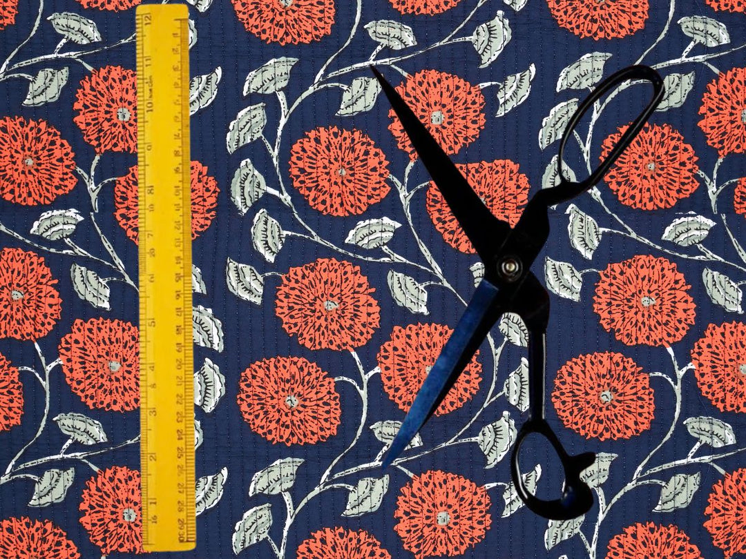 Orange floral quilted fabric by the yard with an Indian-inspired chrysanthemum design