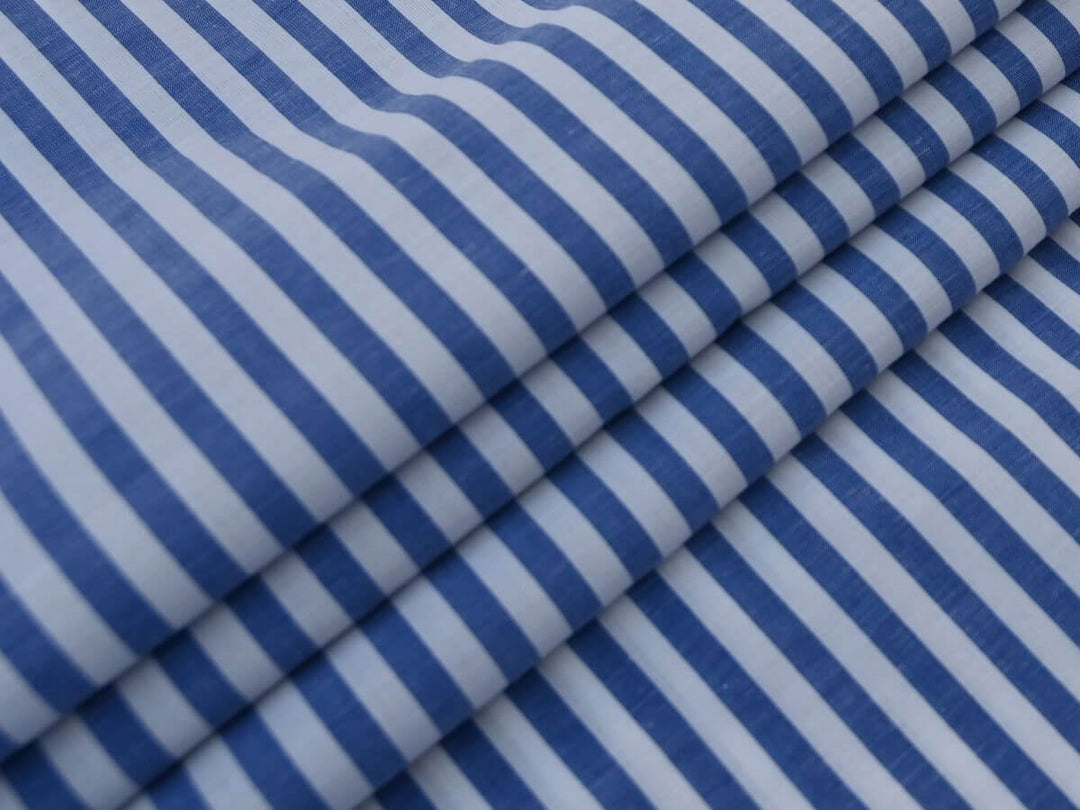 Indian Cotton Stripe Fabric featuring blue and white stripes folded elegantly.