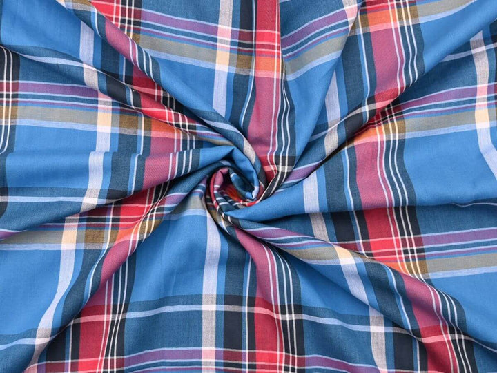 woven plaid tartan fabric by the yard in vibrant blue, red, and yellow colors, ideal for sewing and quilting projects.