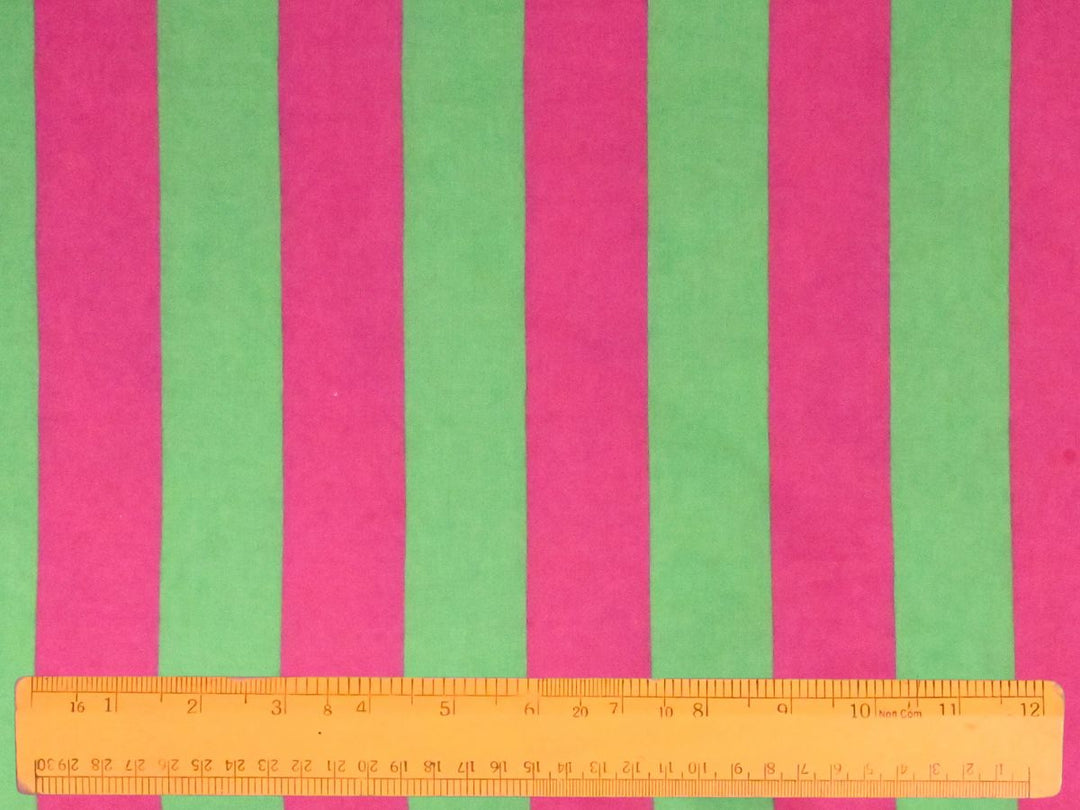 Lightweight curtains made with Indolibas green and pink vertical stripe printed cotton fabric.