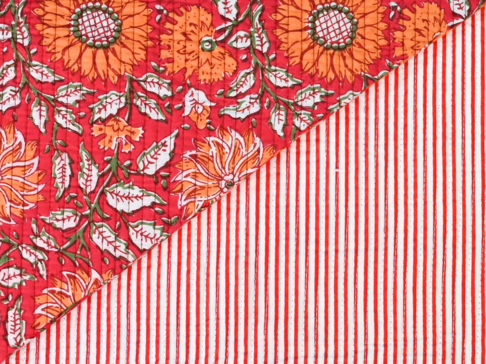 Red floral quilting fabric with orange flowers and green leaves