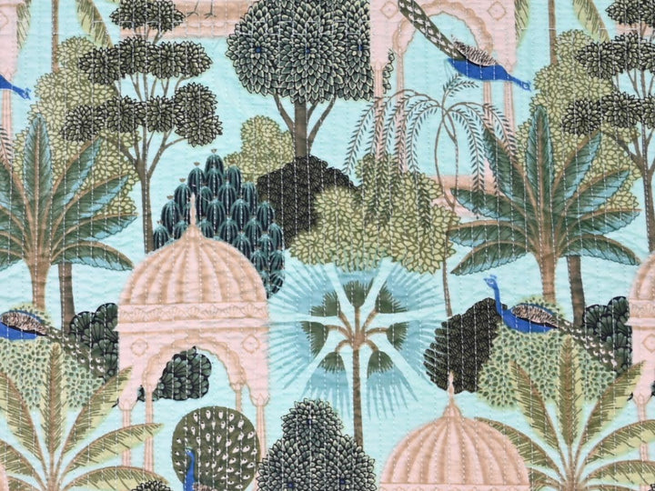 Aqua green tropical quilted fabric with coral pink and blue botanical motifs