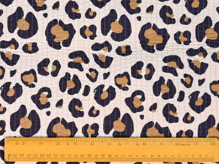 Quilted cotton fabric by the yard with leopard print in navy and tan