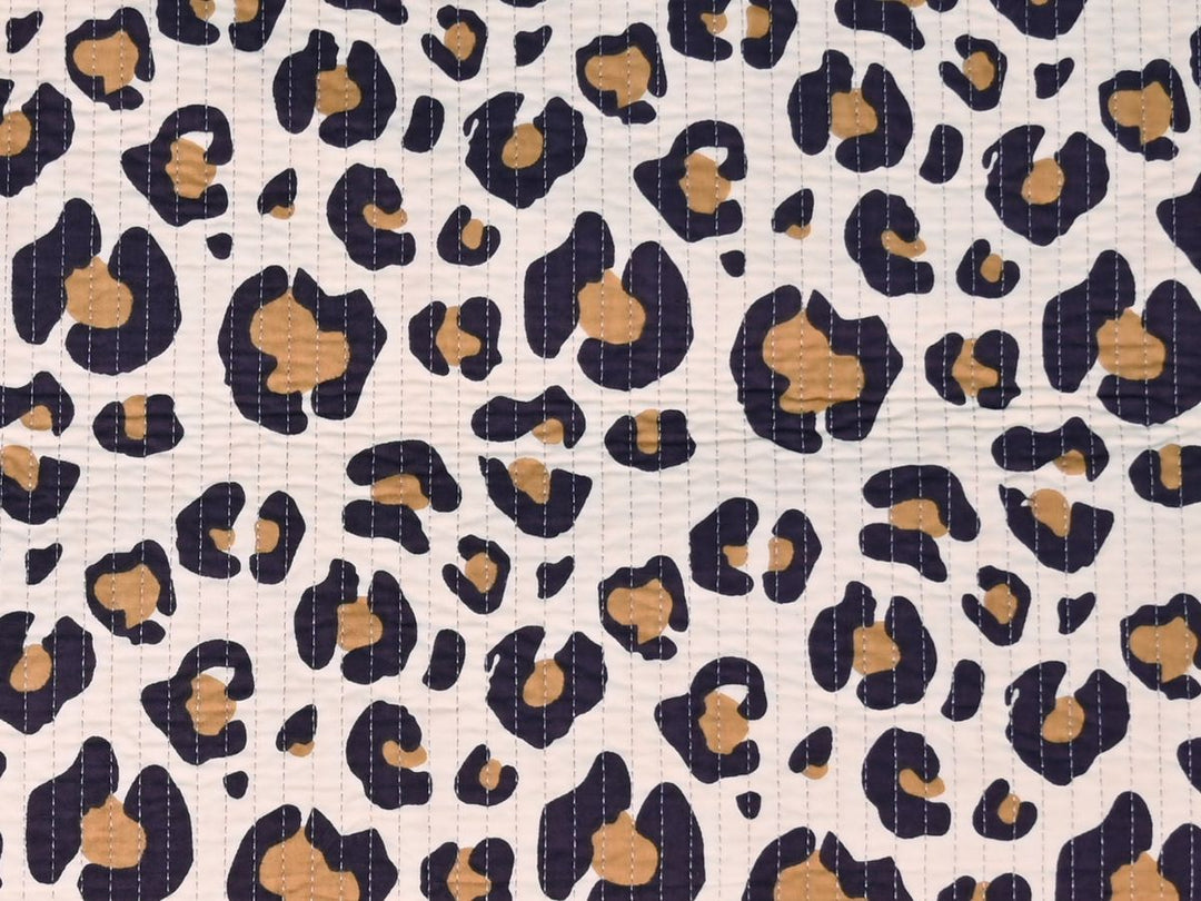 Leopard print quilted fabric showing quilted stitch lines and rosette pattern