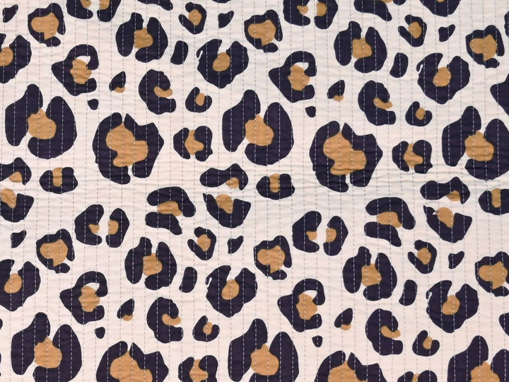 Leopard print quilted fabric showing quilted stitch lines and rosette pattern