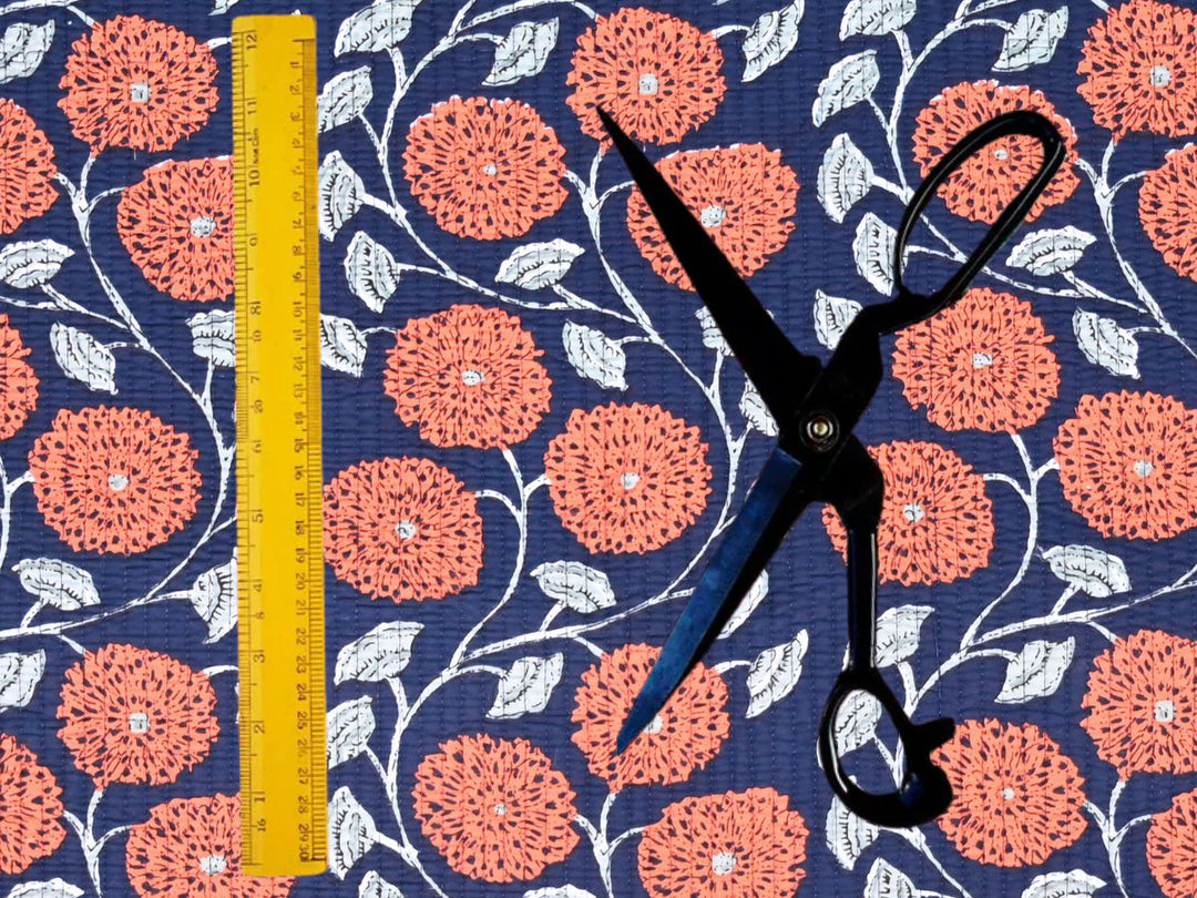 Orange floral quilted fabric by the yard with an Indian-inspired chrysanthemum design