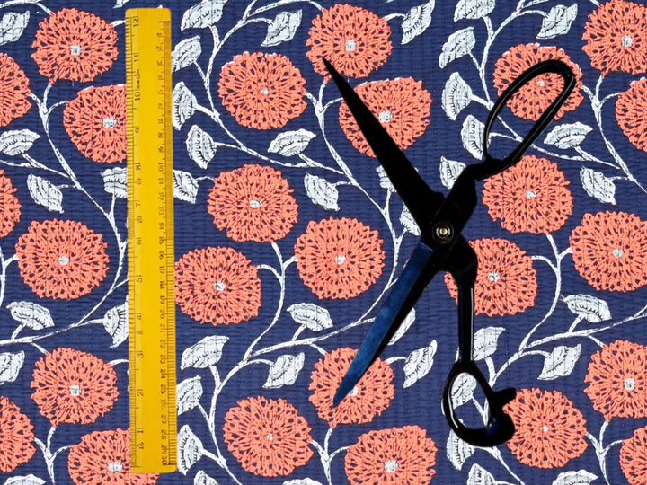 Orange floral quilted fabric by the yard with an Indian-inspired chrysanthemum design