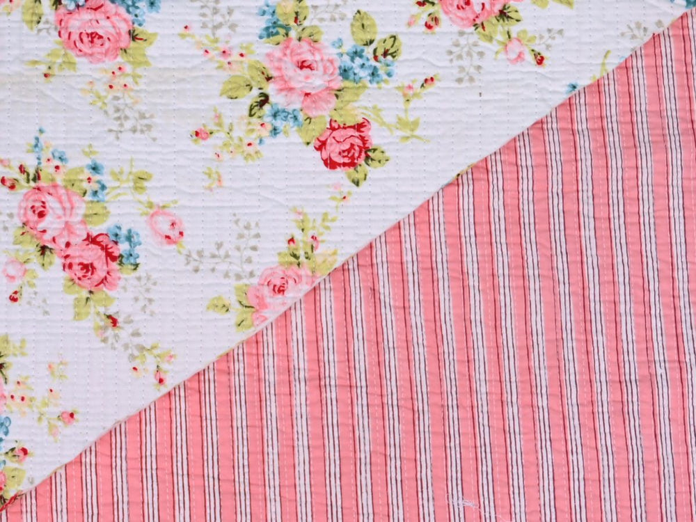 Shabby chic rose quilting fabric with pink, blue, and green floral details
