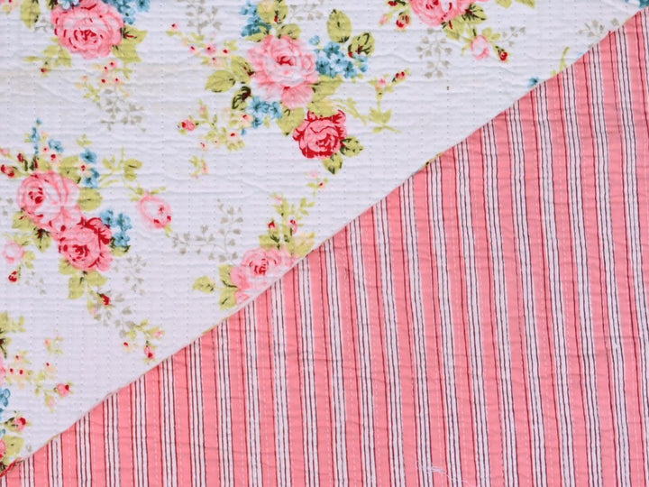 Shabby chic rose quilting fabric with pink, blue, and green floral details