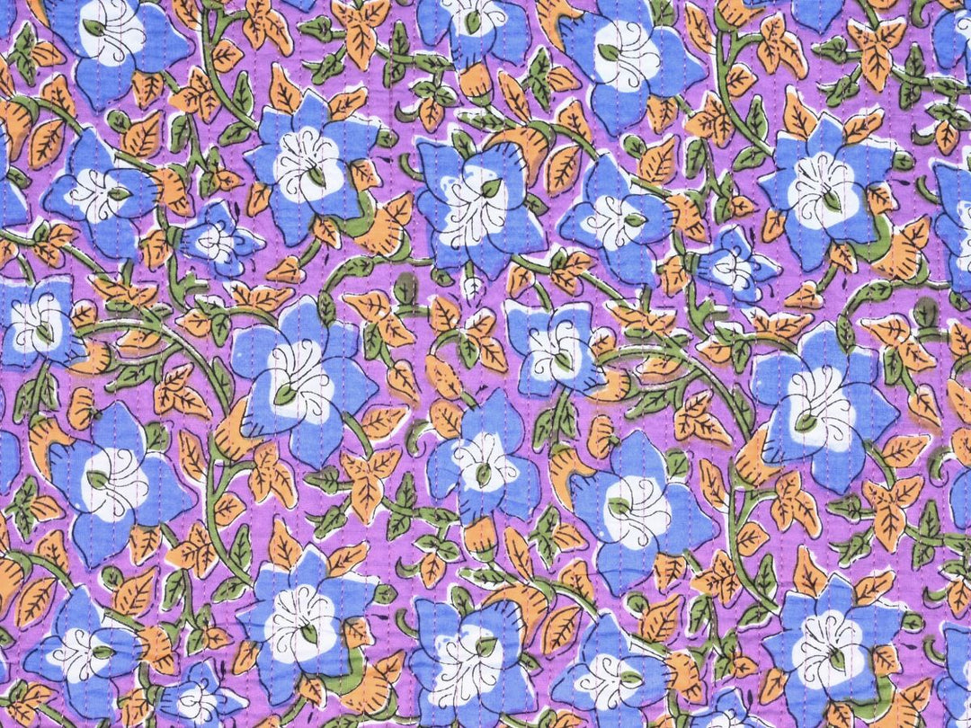 Indian-inspired quilt fabric with blue bell flowers on purple ground