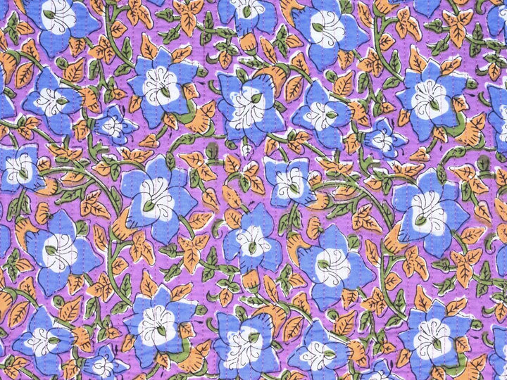 Indian-inspired quilt fabric with blue bell flowers on purple ground