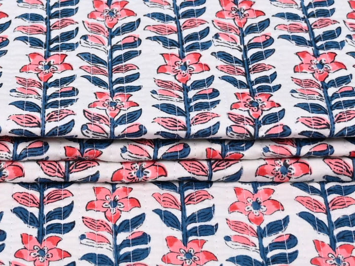 Coral and navy floral quilted fabric for cushions and light upholstery