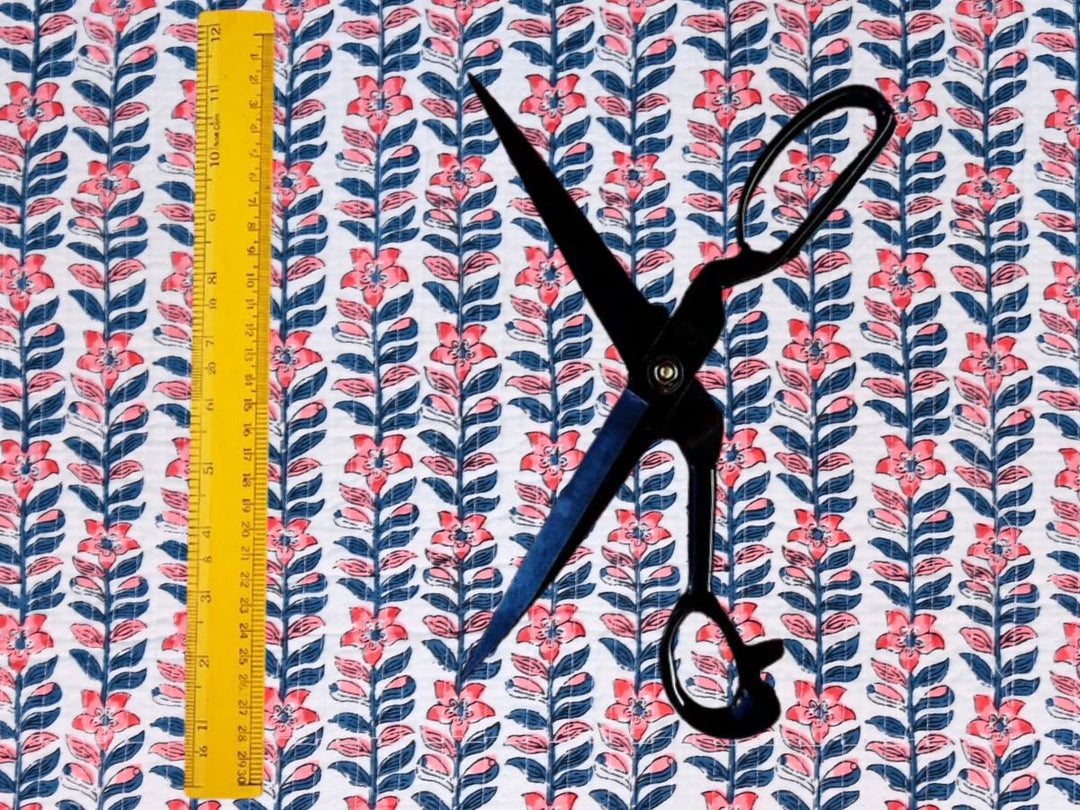 Quilted cotton fabric showing diagonal stitching and block print floral stripe