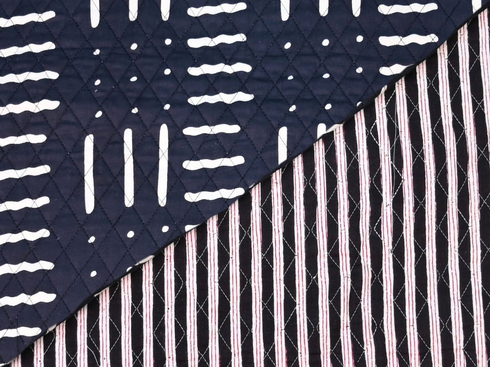Quilted fabric by the yard with black ground and white geometric dash print