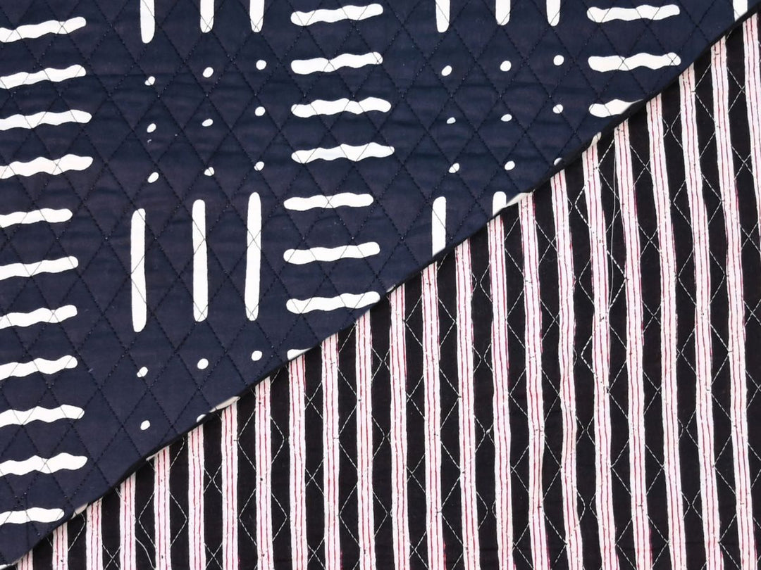 Quilted fabric by the yard with black ground and white geometric dash print